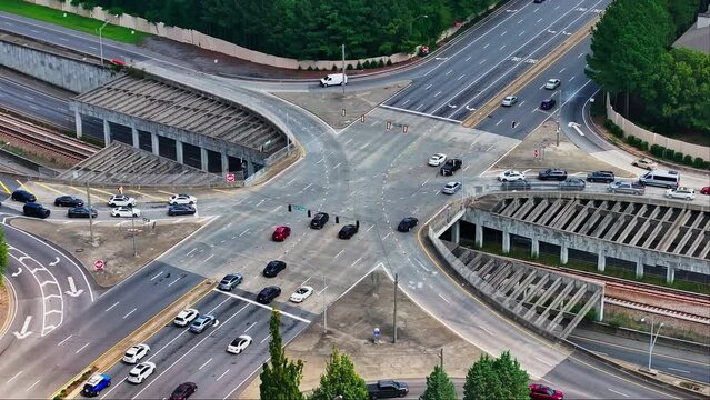 Aerial top down of busy multi lane junction and tracks underpass in American Town.