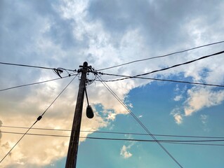 Silhouette of street pole with electrical wires
