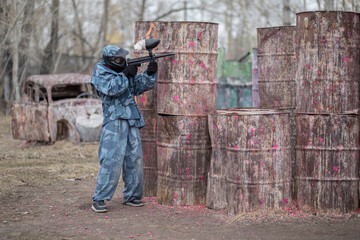 Paintball. Gun and soldier with a sports man playing a military game for fun or training outdoor. War, camouflage and target with a male athlete shooting a weapon outside during an army exercise