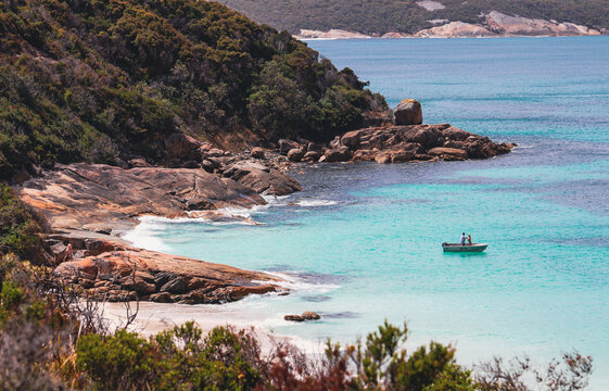 A scenic view over a bay, a small boat adds to the image sat im the clear blue water. Albany, western Australia 