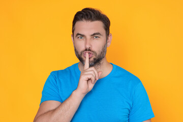 Guy having secret and holding finger on lips. Male model, asks to be quiet. Shh man. Hush shut...