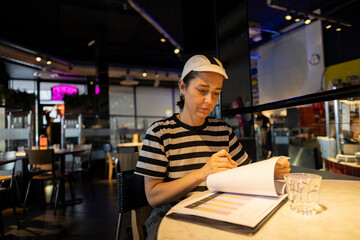 Focused Chef Reviewing Menu Choices in Urban Café