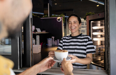 Friendly Chef Serving Coffee Over Café Counter