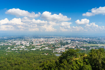 view in the mountains with road cityscape over the city building hotel, shopping mall,temple and houses air cloudy sky background with white cloud.