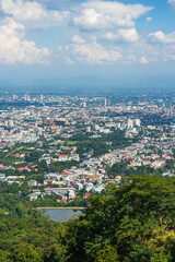 view in the mountains with road cityscape over the city building hotel, shopping mall,temple and houses air cloudy sky background with white cloud.
