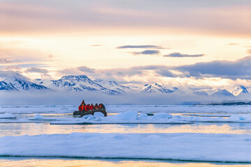 Beautiful arctic landscape view with people in a inflatable boat