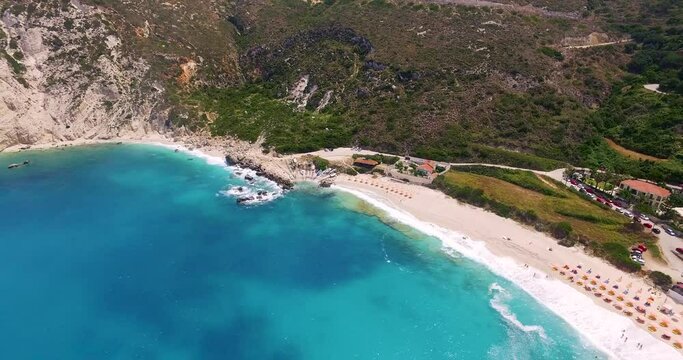 Panning drone shot of the whole stretch of Petanoi beach resort, a secluded getaway in the island of Kefalonia in the Western Coast of Greece.