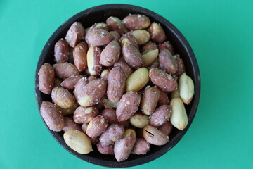 salted pistachios are displayed in traditional and glass containers