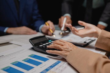 A group of business people are discussing company figures to resolve quarter of the year's losses, A group of employees is meeting to come up with a strategy to increase profits for the company.