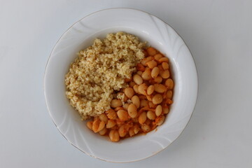 close-up of a traditional Turkish dish of dried beans and bulgur pilaf, white background