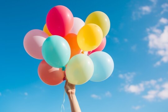 
A close-up Hopecore-inspired photo of a person's hands releasing colorful balloons into the sky, representing a release of positivity and joy into the world