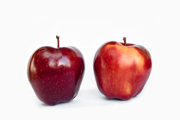 Two apples of the Red Delicious variety on a white background isolated