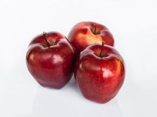 Fototapeta na wymiar Three Red Delicious apples isolated on white background with reflection