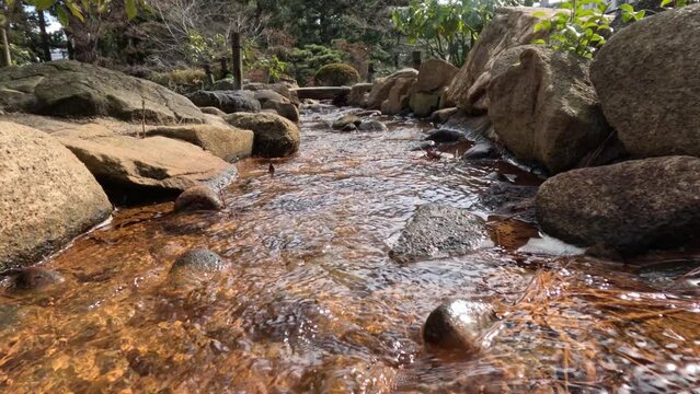 Tranquil Stream Flowing Through Rocks