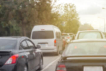 Fototapeta premium Blurred row of car on evening treaffic jam hour and copyspace