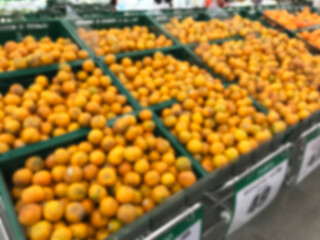 Blurred tangerines in supermarket