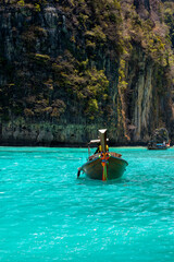 A boat sailing on turquoise water. Phi Phi Island in Thailand.