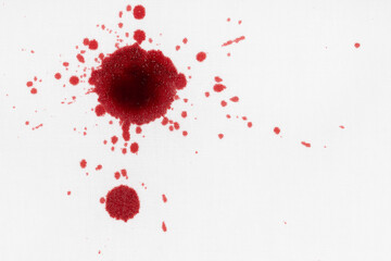 Drops of blood stains on white fabric. blood splatters on clothes. red dripping blood spatters