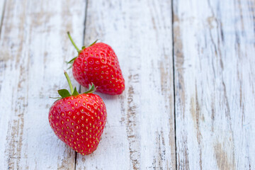 Fresh strawberries on old white wooden background