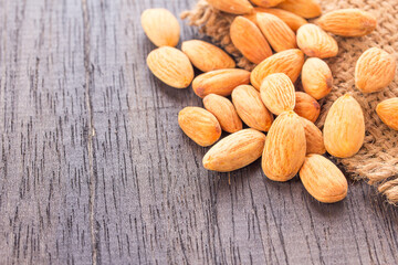 Almonds on wooden table background.