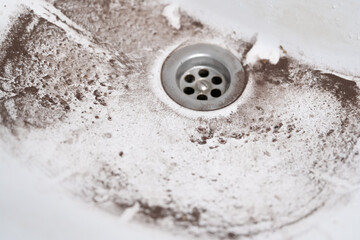 white sink drain with dirt close up