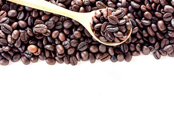 Close up coffee beans in wood spoon on white background.
