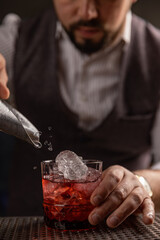 Bartender pouring cocktail at bar - 763003367
