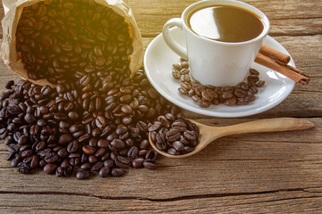Hot coffee and coffee beans on wood table background