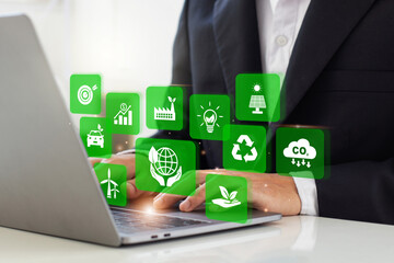 Businessman analyze sustainability investment with icons of green business. Concept of Sustainable development. ESG, Co2, CSR, Green technology, Net zero, green energy and Carbon credit. Copy space. - obrazy, fototapety, plakaty