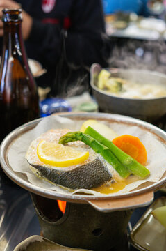 Japanese food set or "teishoku" contain fish, asparagus, carrot, and lemon slice served in restaurant.