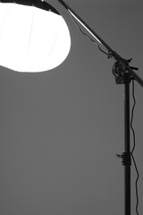 Photo Studio Light. Lantern Modifier on Crane Light Stand on Studio Cyclorama Background.   - obrazy, fototapety, plakaty