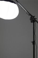 Photo Studio Light. Lantern Modifier on Crane Light Stand on Studio Cyclorama Background.  Flash...