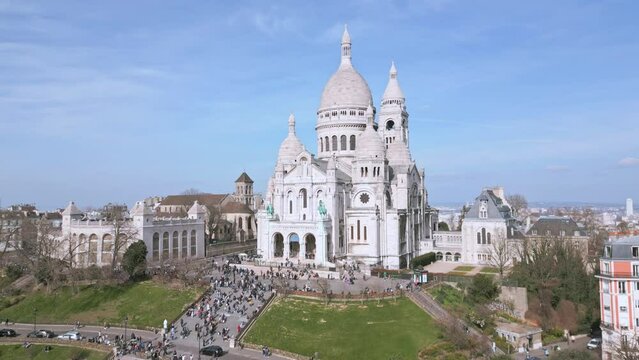 Crowd of people at Basilica of Sacre Coeur, Montmartre hill in Paris, France.  Aerial ascending