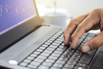 Fingers typing on the computer keyboard, simple close up with lens flare