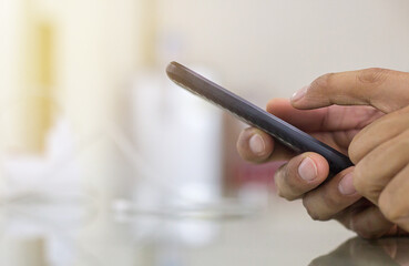 Close up of a businessman using mobile smart phone