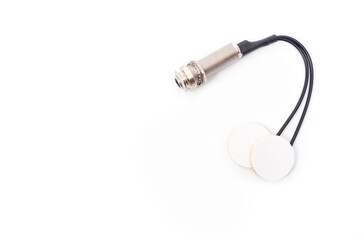 Piezo pickup for musical instruments with two sensors and a socket for connecting a jack cable.