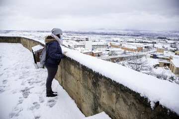 Woman looking at the snow - 763027548