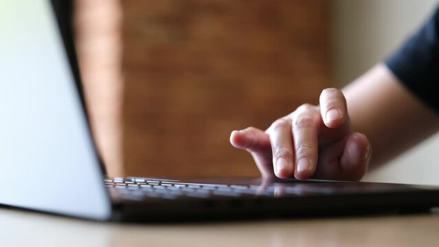 Closeup of a hand touching on laptop touchpad