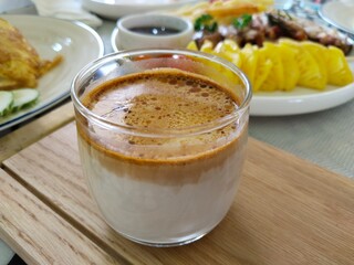 Dirty coffee that combines double shot of espresso and milk in a chilled glass