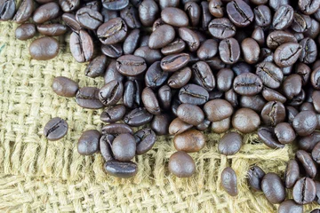 Fotobehang Top view of coffee beans on old wooden background. © nilawan