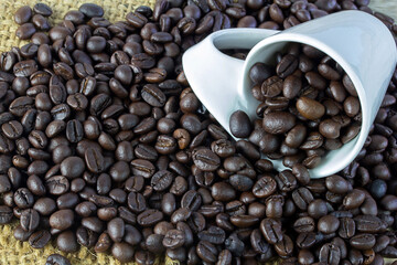 Top view of coffee beans on old wooden background.