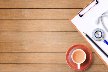 Top view with medical clipboard,pencil,blue stethoscope and cup of coffee on wood table background. Healthcare and medical - obrazy, fototapety, plakaty