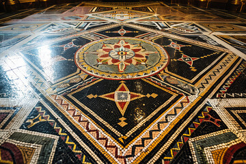Mosaic floor pattern in a Masonic temple, depicted in intricate geometric designs and symbolic motifs, captured from a bird's eye view to showcase the precision and complexity of the artwork.