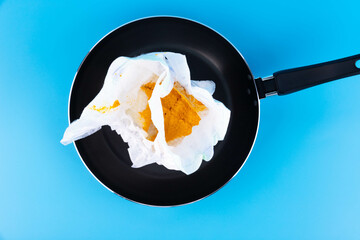 Concept, offer, hot news, fake news. Dirty diaper in the pan. Hot offer