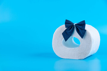 roll of toilet paper wrapped in gift bow. The concept of a valuable actual gift