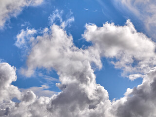 Obraz premium White fluffy clouds in the deep blue sky. Heaven background