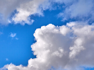 Obraz premium White fluffy clouds in the deep blue sky. Heaven background