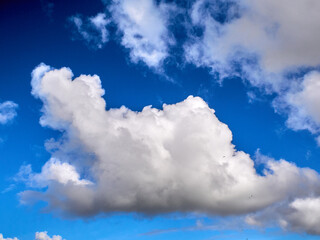 White fluffy clouds in the deep blue sky. Heaven background