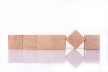Six wooden cubes with empty space for copy words, messages, lie on a white reflective background....