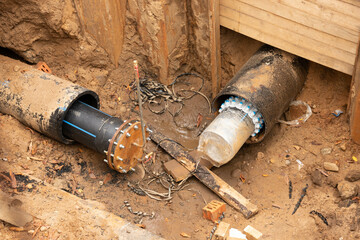 Arranged PVC of water pipes are assembled and placed in trench on building site.